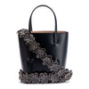 Navy leather tote with studded floral strap