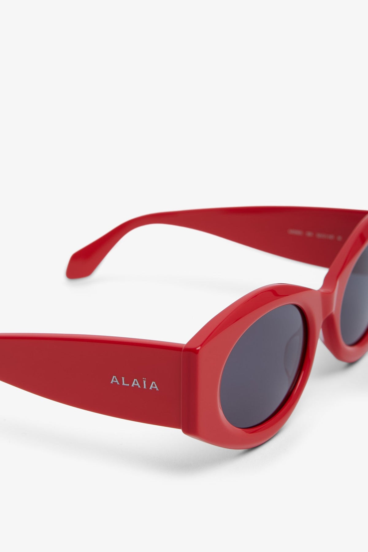 Shop Alaïa Oval 82 Red Sunglasses